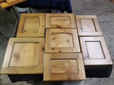 several pieces of wood sitting on top of each other in the middle of a floor