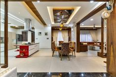 an open living room and dining area with marble flooring, white walls and ceiling