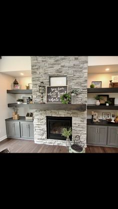 a living room filled with furniture and a fire place in front of a stone fireplace