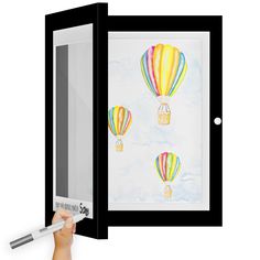 a drawing of hot air balloons is shown in an open window with a marker on it