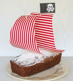 a piece of bread on a plate with a red and white striped boat