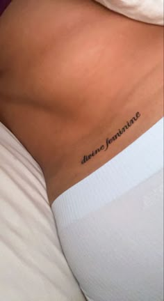 the back of a woman's stomach with an inscription on it that reads, june feminine