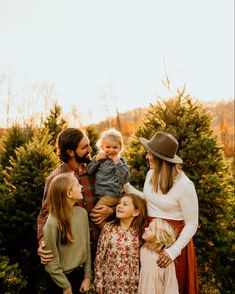 a family standing in front of a christmas tree