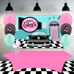 a car is parked in front of a party backdrop with balloons and music notes on it