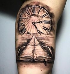 a man with a book and clock tattoo on his arm is holding an open book