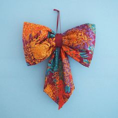 an orange and red bow tie on a blue background