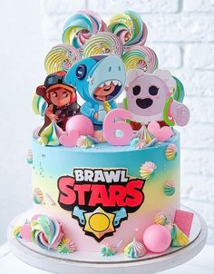 a birthday cake decorated with cartoon characters and balloons