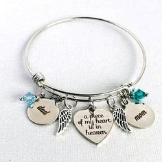 A nice way to remember both parents. ~ Stainless steel, adjustable bangle is 60mm, and fits a 6-8 wrist. ~ stainless steel, laser engraved A Piece of my Heart is in Heaven charm ~ stainless steel mom and dad charms ~ antique silver angel wing charms ~ sparkling Swarovski crystal Mother's Day Engraved Stainless Steel Charm Bracelet, Mother's Day Stainless Steel Charm Bracelet, Personalized Meaningful Stainless Steel Bracelets, Meaningful Personalized Stainless Steel Bracelets, Hypoallergenic Stainless Steel Jewelry For Memorial, Mother's Day Nickel-free Stainless Steel Charm Bracelet, Personalized Stainless Steel Jewelry For Memorial, Hypoallergenic Stainless Steel Bracelets For Anniversary, Adjustable Stainless Steel Keepsake Jewelry