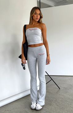 The A Power Move Flare Pant in Grey Marle is perfect for those chill days! Featuring a low-rise fit, elasticated waist band, slim fitting, folded waistband, slight flared leg and embroidered logo front side. Pair with the matching A Power Move Oversized hoodie or Strapless Top for the perfect off-duty fit! - 95% Cotton Casual Elastane Pants For Streetwear, Casual Elastane Streetwear Pants, Casual Streetwear Elastane Pants, Fitted Cotton Athleisure Pants, Fitted Cotton Pants For Athleisure, Fitted Sweatpants With Elastic Waistband For Leisure, Fitted Athleisure Bottoms For Leisure, Fitted Cotton Sweatpants For Leisure, Fitted Leisure Pants For Summer