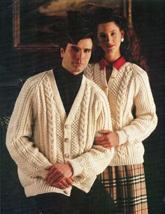 a man and woman wearing sweaters standing next to each other