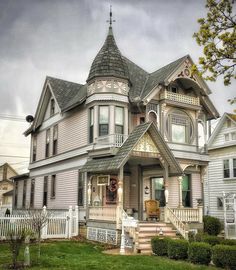 an old victorian style house on a cloudy day