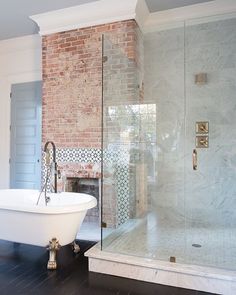 a bathtub sitting next to a brick wall in front of a white tub with pink letters on it