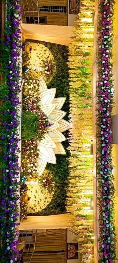 the interior of a building decorated with flowers and greenery