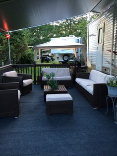 an outdoor living area with couches and chairs