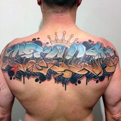 the back of a man's upper body with graffiti on it