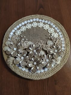 a basket that has flowers on it sitting on a table next to a wooden floor