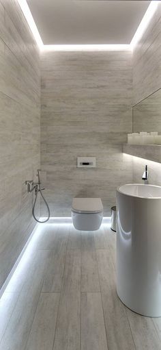 a bathroom with a toilet, sink and shower in the center is shown on instagram