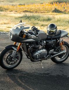 a motorcycle parked in a parking lot next to a field