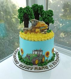 there is a cake that looks like a tractor and trees on top of the cake