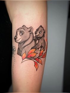 a bear and cub tattoo on the arm