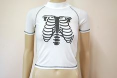 "FREE SHIPPING WORLDWIDE FOR ALL ADDITIONAL ITEMS PURCHASED  -1990s vintage white rib cage skeleton rashie top -Super petite tight fit -Spandex stretch fabric -High rounded neckline -Semi sheer and lightweight MEASUREMENTS:  - Length: 48cm (19\") - Bust: 46cm (18\") - Waist: 46cm (18\") - Armhole width: 16cm (6.6\") Material: Polyester/Spandex Estimated fit: XXS-XS Condition: It looks slightly a pale yellow on front. Excellent vintage Measurements taken while garment is laying flat x2 for full circumference. Check the measurements before purchasing. Your item will be sent within 1 business day.♡" 90s Rave, Skeleton T Shirt, Lovely Tops, Cropped Tee, Rounded Neckline, Beautiful Skirts, Rib Cage, Pale Yellow, Crop Tee