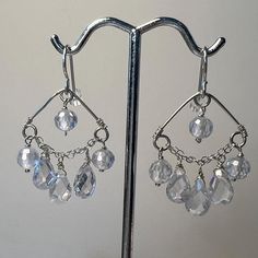 "Handmade jewelry, inspired by nature, to positively affect the wearer".  These crystal chandelier earrings are captivating!  Czech crystals are suspended from chain to look like a waterfall.  The crystals sparkle in all types of light, whether you are indoors or in moonlight - you will love the way these look!  Fun to wear and perfect to have on hand for special occasions, such as a wedding, a party or a night out.      SILVER SYMBOLIC MEANING: Purity, Protection, Balance; expands awareness CRYSTAL SYMBOLIC MEANING: Spiritual Growth, Clarity, Balance and Alignment    ITEM DETAILS: *Handmade Item *Genuine Czech Crystal *Sterling Silver French Earwires *Sterling Silver chain and wire *Length is 1-3/8 inches *Rubber earring backs are included to ensure earrings stay put *Jewelry box included Long Drop Chandelier Earrings With Dangling Beads For Gift, Drop Chandelier Earrings As A Gift, Drop Chandelier Earrings For Gift, Silver Plated Dangle Crystal Earrings, Gift Drop Chandelier Earrings With Ear Wire, Long Drop Chandelier Earrings As Gift, Gift Long Drop Chandelier Earrings With Ear Wire, Unique Dangle Chandelier Earrings, Silver Crystal Chandelier Earrings