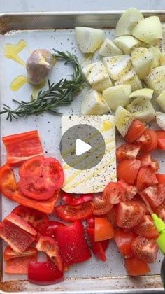 the cutting board has chopped up tomatoes and other vegetables on it, including onions, carrots, and garlic