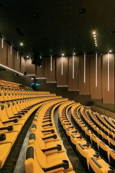 an empty auditorium with rows of yellow seats