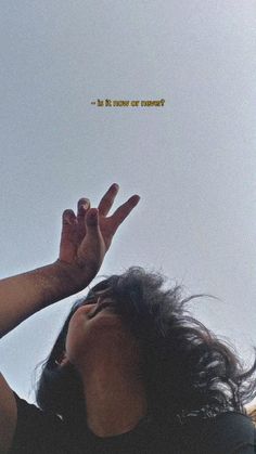 a woman reaching up to the sky with her hand in front of her face and an inspirational quote above her head