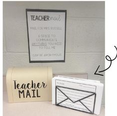 two mailboxes are sitting next to each other in front of a sign that says teacher mail