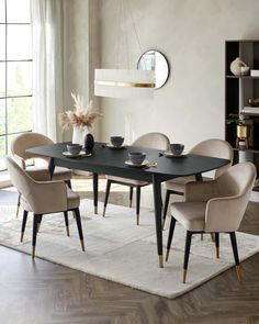 a dining room table with chairs and plates on top of it in front of a large window