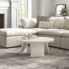 a living room filled with furniture and a fire place next to a white couch in front of a fireplace