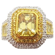 Yellow Sapphire 3.30 carats with Yellow Sapphire 1.12 carats and Diamond 0.45 carat Ring set in 18 Karat White Gold Settings Width: 1.4 cm Length: 1.6 cm Ring Size: 53 Total Weight: 10.53 grams "We first opened doors in 1980 when it was then situated in the vicinity of the Victory Monument; a small and modest storefront with a couple of counters. From its humble beginnings to where it stands today, our company has proven its abilities as a jeweler. Since the beginning, we have been supplying fin Yellow Baguette Cut Diamond Ring With Vvs Clarity, Yellow Diamond Ring With Emerald Cut, Yellow Emerald-cut Diamond Ring, Yellow Diamond Ring With Emerald Cut Center Stone, Yellow Emerald-cut Ring With Diamond Accents, Yellow Emerald Cut Rings With Diamond Accents, Yellow Emerald Cut Diamond Ring With Halo Setting, Yellow Emerald Cut Ring With Diamond Accents, Luxury Yellow Baguette Cut Ring