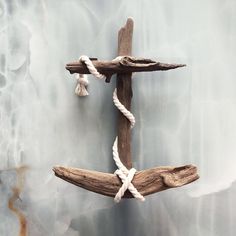 a cross made out of driftwood and rope