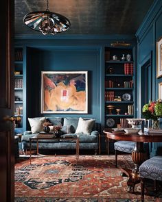 a living room with blue walls and rugs on the floor is featured in an instagram