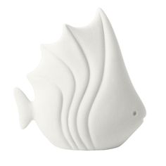 a white ceramic fish sculpture sitting on top of a table