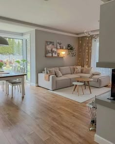 a living room filled with furniture and a flat screen tv on top of a hard wood floor