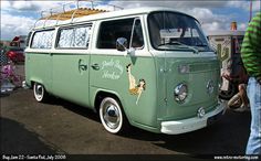 an old vw bus parked in a parking lot