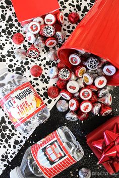 a table topped with lots of candy and candies next to a red lamp shade