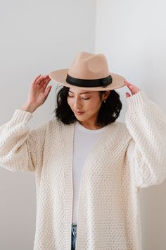 Meet the Goldie! This darling wool hat is our new fave. The Goldie features a subtle black bow on the band for a feminine touch, as well as a semi-structured shape. The Goldie has a 3" brim and a 5" crown. Chic Fedora Panama Hat For Fall, Chic Fall Fedora Panama Hat, Chic Brimmed Panama Hat For Fall, Beige Fedora Hat For Fall, Chic Everyday Felt Hat For Fall, Classic Beige Panama Hat For Fall, Chic Beige Fedora For Fall, Adjustable Panama Hat For Fall, Elegant Fedora For Fall