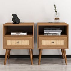 two nightstands side by side with books and magazines on each shelf, against a white wall