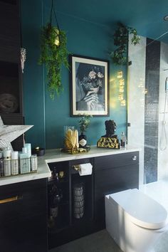 a bathroom with blue walls and white fixtures