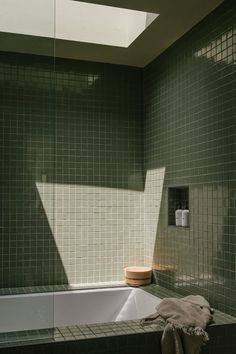 a bath tub sitting under a window in a bathroom