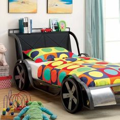 a child's bedroom with colorful bedding, toys and artwork on the walls