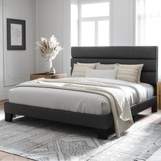 a large bed sitting on top of a wooden floor