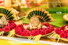 an arrangement of flowers and decorative items on a table with candles in the center for diwaling