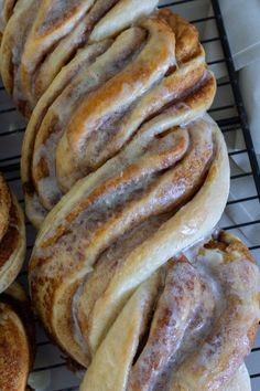 several cinnamon rolls sitting on top of a cooling rack