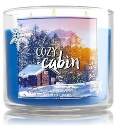 an image of a candle with the words cozy cabin on it