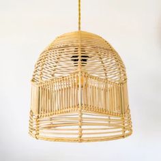 a wicker light fixture hanging from a ceiling