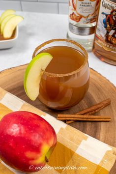 an apple and cinnamon drink on a wooden tray